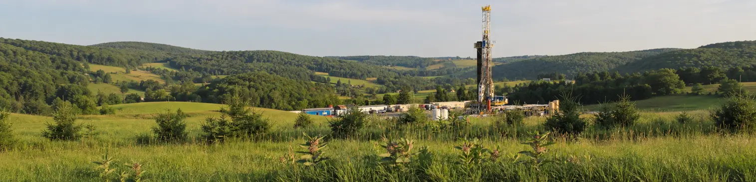 Onshore drilling rig in a rural landscape illustrating oil and gas sustainability